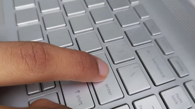 Finger Pressing Enter Key on Laptop Keyboard