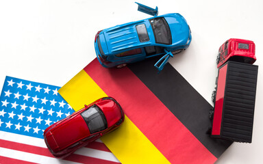 Mini toy car and flags of the USA and Germany