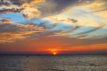 Colourful sunset over sea with it's reflection as background