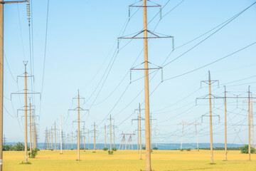 High-voltage power line in the field. Electricity pylons in the evening. Electric tower. Power transmission lines. energy security and clean energy.  