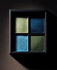 Fototapeta premium black box containing four blue and dark green eyeshadows