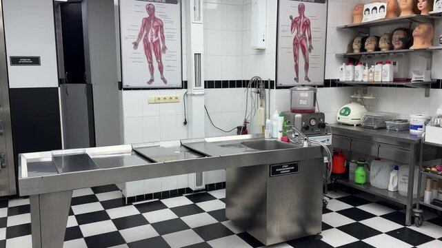 Autopsy table in a hospital. Empty modern morgue. Examination of a body after death, preparation of a corpse for burial, cremation in a crematorium.
