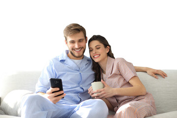 Young couple watching online content in a smart phone sitting on a sofa at home on a transparent background