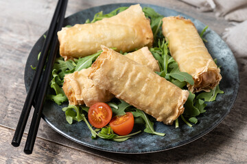 Crispy vegetables spring Rolls on wooden table