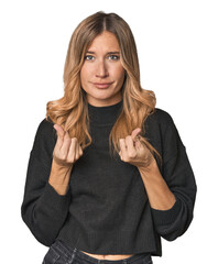 Caucasian blonde woman in studio showing that she has no money.