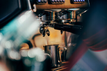 Professional espresso machine brewing coffee with metallic mug in cozy cafe Vietnam setting