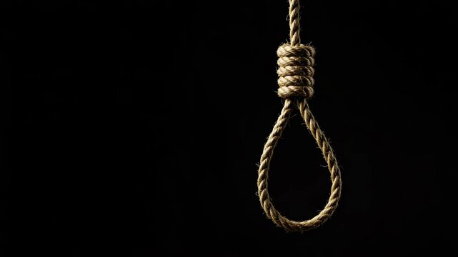 Rope noose hanging against black background for symbolism  
