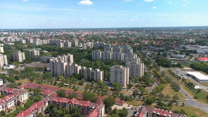 Obraz premium Densely populated urban area, apartment blocks, panel flats, residential buildings, well planned green spaces. Structured city layout, road network, and modern infrastructure. Housing estates. 