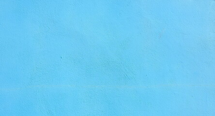 Light blue wall with subtle texture and crack details
