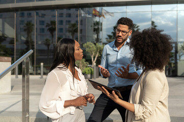 Group of diverse multiethnic Business team having a conversation outside office building