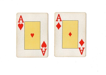 A blackjack or pontoon hand of vintage playing cards on a white, background.