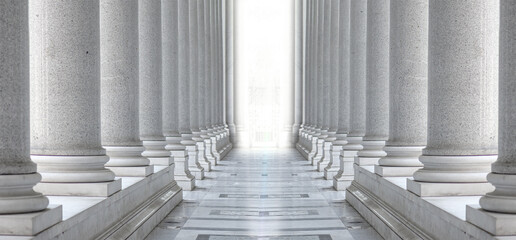 Two rows of white marble columns. Hallway with white pillars.