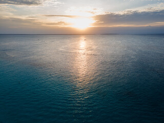 Naklejka premium Golden sunset illuminating calm ocean in Zanzibar, Tanzania