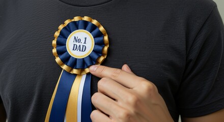 Close up of a person proudly wearing a No. 1 DAD award ribbon. Father's Day recognition and appreciation concept.