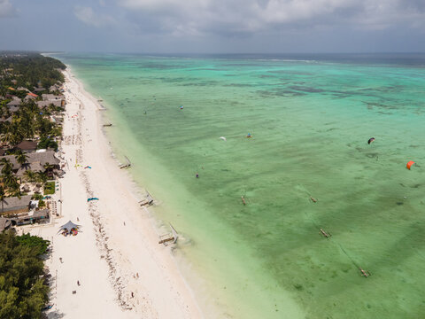 Tourists kitesurfing in turquoise water at paje beach, Zanzibar, Tanzania