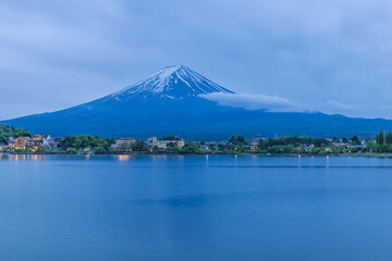 Admiring the beautiful Mount Fuji at dusk over Lake Kawaguchi, Yamanashi Prefecture, Japan.