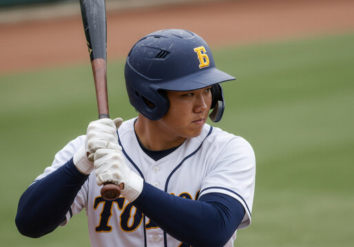 Baseball player in batting stance wearing navy blue helmet and white uniform
