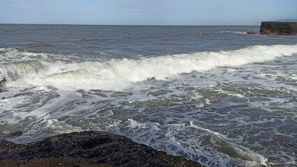 Powerful Ocean Waves Crashing Against Coastal Rocks