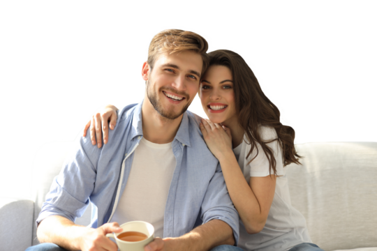 Portrait of cute young couple sitting in sofa on a transparent background