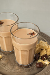 Cups of Indian masala chai on a metal try