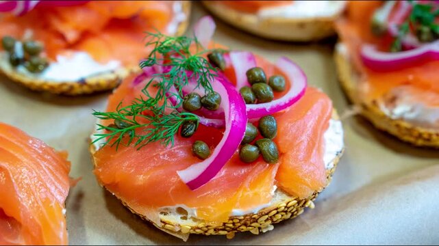 Delicious bagel sandwiches topped with salmon, onions, dill, and capers.