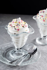 Whipped Cream Delight with Sprinkles on gray stone background