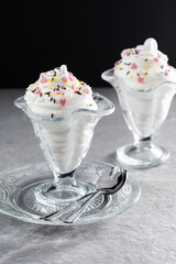 Whipped Cream Delight with Sprinkles on gray stone background