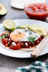 Huevos Rancheros. Traditional Mexican breakfast on wooden table