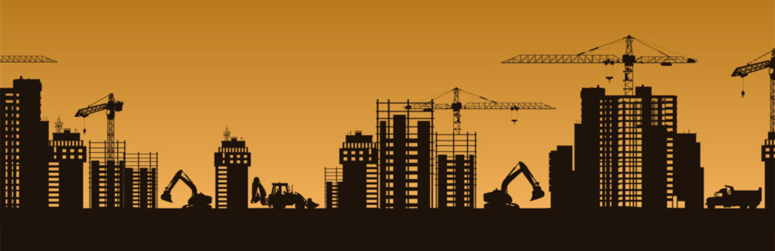City skyline at sunset featuring building silhouettes with cranes in a construction scene.