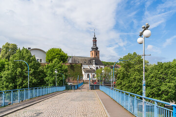 View of the castle church across the deserted old bridge in Saarbrucken in Germany the sky is blue and cloudy
