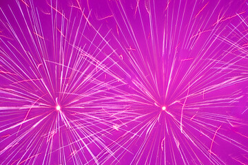 holiday card backdrop: close up of several bright fireworks against purple sky
