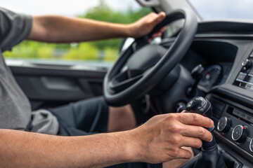 Manual gear shifting. Hand on gear lever. Driving with manual transmission.