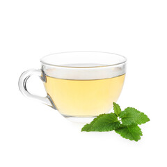 Aromatic lemon balm tea in glass cup and fresh leaves isolated on white