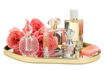 Many different perfume bottles and roses isolated on white