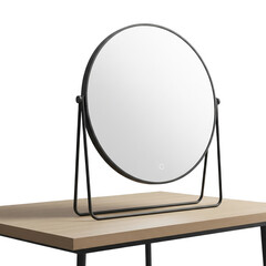 Round black vanity mirror with illuminated ring, resting on a light wood table