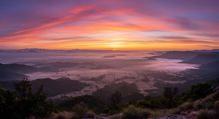 Fototapeta premium Mountains Landscape Covered in Fog During Sunrise with Vibrant Sky