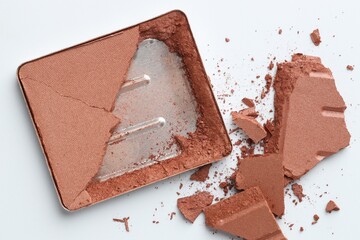 Broken eyeshadow refill pan on white background, top view