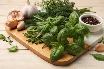 Different fresh herbs and spices on white wooden table, closeup