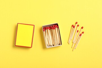 Matches and box on yellow background, flat lay. Mockup for design