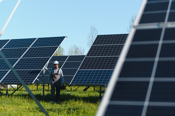 Skilled technician installing solar panels on sunny day