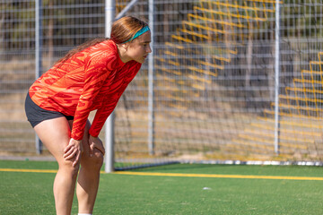 Girl soccer player. Girl in sports uniform on the soccer field. Football concept.