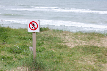 No Trespassing Sign at Coastal Grassland by the Baltic Sea in Staldzene. No Passing in Dunes, Walking Prohibited. Do not enter.