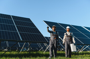 Workers installing solar panels in solar power station