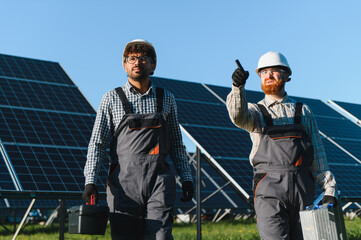 Engineers installing and maintaining solar panels in solar power station