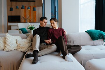 Couple enjoying a cozy moment together in a modern living room setting