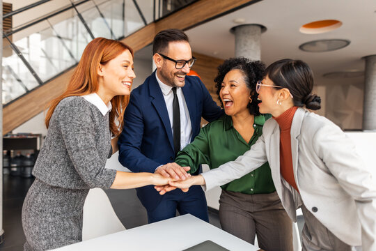 Business Team Showing Unity Through a Motivational Collaboration Gesture
