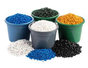 Four containers filled with granulated plastic pellets in blue, white, green, and yellow, with additional piles of pellets in front of each container.