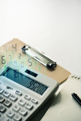 Calculator with financial figures and a digital overlay, representing accounting and financial analysis