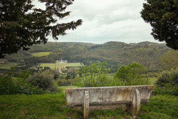 A bench overlooking the beautiful landscape of Italian Tuscany