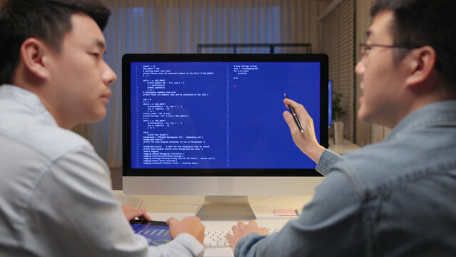Smart AI cyber bot deep tech tools help write prompt code screen. Asia people asian man IT team typing busy talking work on predict big data center office reskill upskill STEM expert skill job course.
